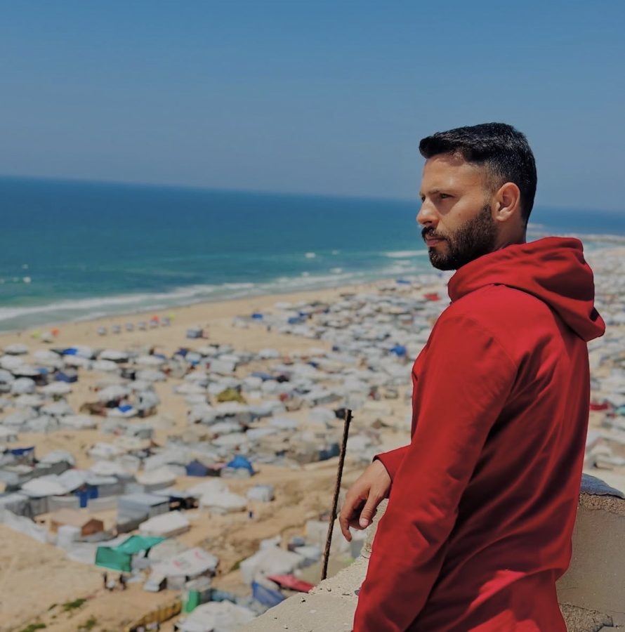 Abdullah looking out over a tent camp by the sea