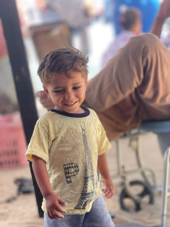 A boy in a yellow shirt