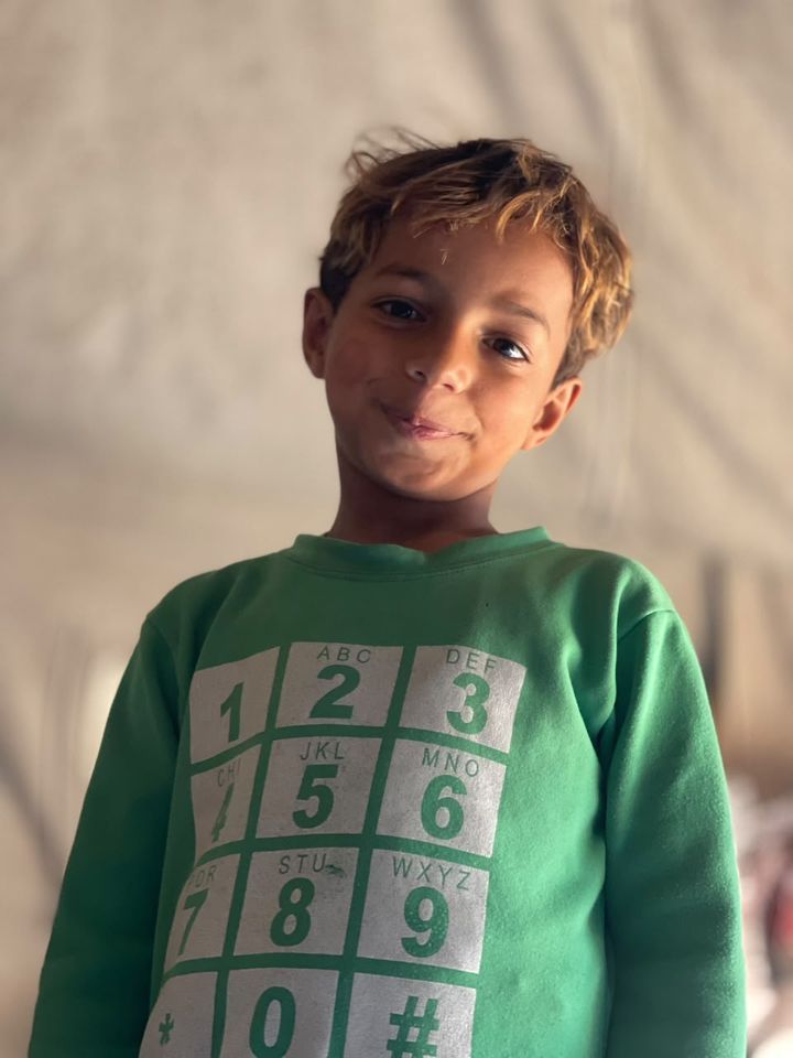 A boy in a green sweater
