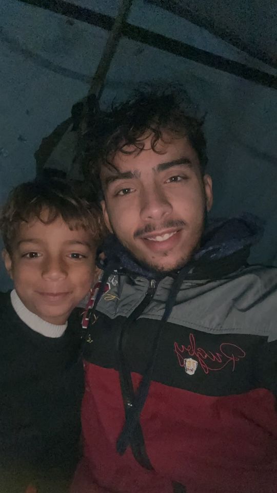 A boy and a young man taking a selfie together