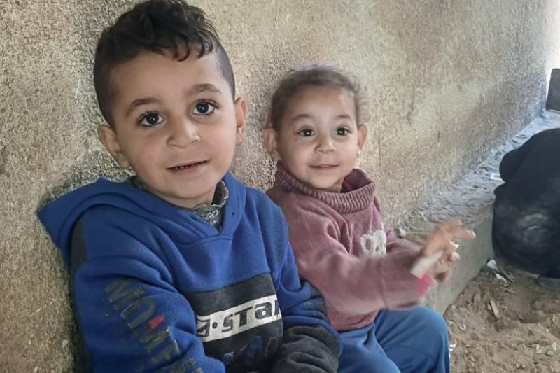 Two young children from the family sitting together