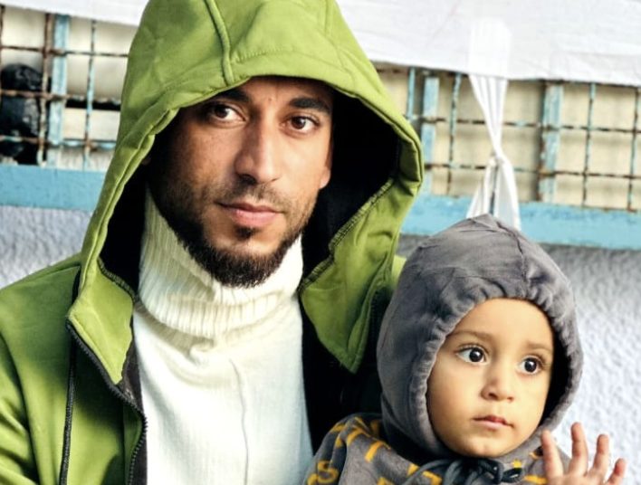 A father and his toddler, both in hooded jackets