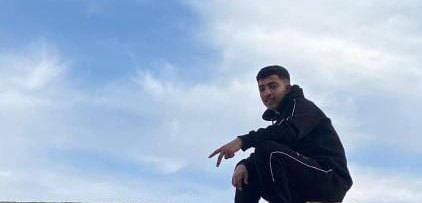 Zain sitting on top of a damaged building