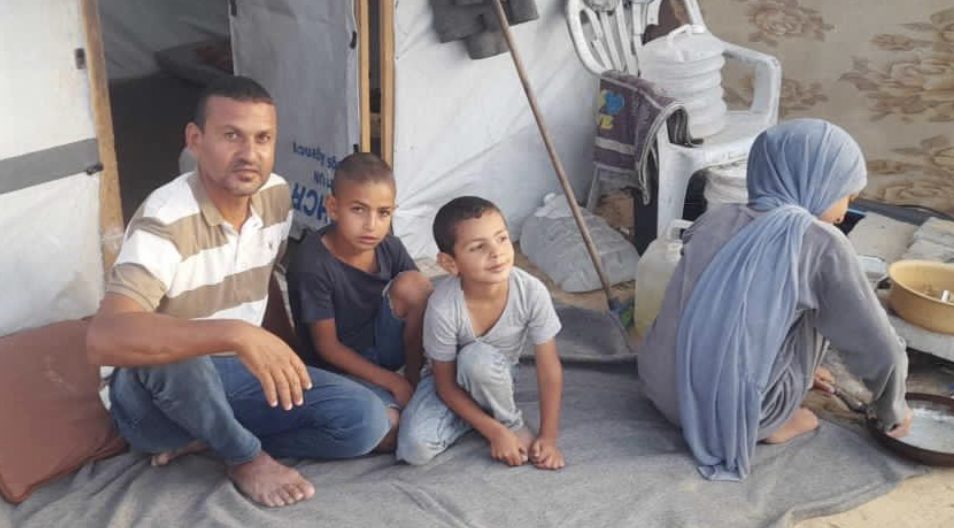 Ziad and his family in their tent in Khan Younis